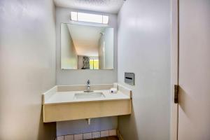 a bathroom with a sink and a mirror at Motel 6 Jeffersonville, IN in Jeffersonville