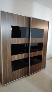 a large wooden cabinet with a television in it at 2 STUDIO in Budapest