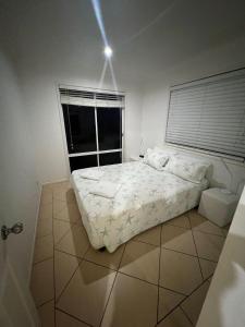 a bedroom with a large bed and a window at Selmar Place in Windermere