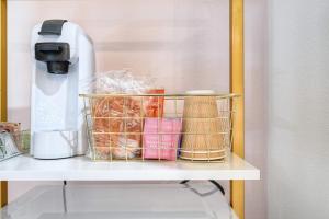 a shelf with a coffee maker and some food at The Oleander Hotel Room Number 2 in Galveston