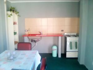 a kitchen with a table and a sink and a stove at Matices in Gualeguaychú