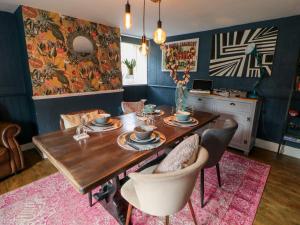 a dining room with a wooden table and chairs at Pepper Cottage in Bishop Auckland