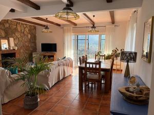 a living room with a couch and a table in it at Villa Amaris a una hora de madrid in Santa Maria del Tietar