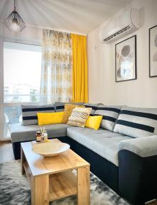 a living room with a blue couch and a table at Art Apartment for 4 People Free Parking & Wifi in Stara Zagora