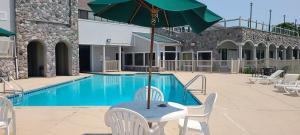 a table with an umbrella next to a swimming pool at Bay Valley Resort in Bay City