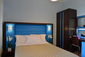 Postel nebo postele na pokoji v ubytování Hotel Rosignano