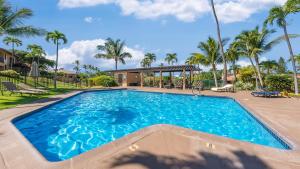 a large blue swimming pool with palm trees at Wailea Ekahi 21F in Wailea