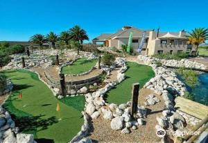 a golf course with rocks and a house at Langebaan Golf Studio B1 - Langebaan Golf Estate in Langebaan
