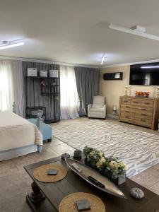 a living room with a bed and a table at Hermosa Flor apartment( Duplex). in Pensacola