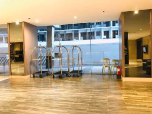 a lobby with three bar stools in a building at Shawnalyn Condo-tel at Mall of Asia Philippines in Manila