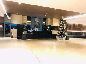 a christmas tree in the middle of a lobby at Shawnalyn Condo-tel at Mall of Asia Philippines in Manila