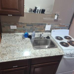 a kitchen counter with a sink and a stove at 070A Cozy Studio with Kitchen near South Rim Sleeps 4 in Valle
