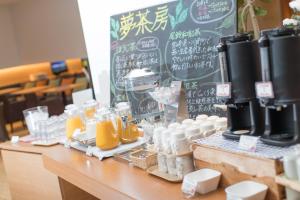 a counter with bottles of orange juice and a chalkboard at JR Kyushu Hotel Miyazaki in Miyazaki