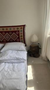 a bedroom with a bed with a pillow and a lamp at Rusiborek Slow in Murzynowo Kościelne