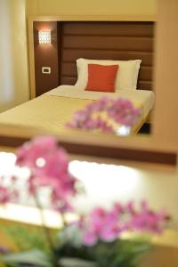 Кровать или кровати в номере Hotel Rosignano