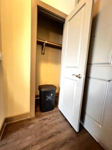 an open door to a closet with a trash can at Luxury Suite in the heart of Dallas, a Home away from Home! in Richardson