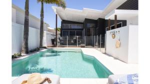 a swimming pool in the backyard of a house at Fennes On Banzai in Kingscliff