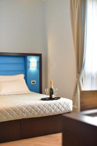 Postel nebo postele na pokoji v ubytování Hotel Rosignano