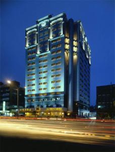 Santos Hotel في تايبيه: مبنى كبير عليه علامة في الليل