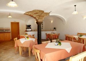 a restaurant with two tables and a stone pillar at Bio Ferienhof Heiler in Feldkirchen-Westerham