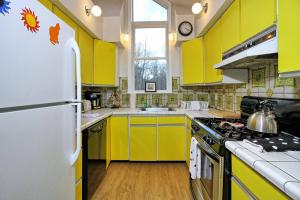 eine Küche mit gelben Schränken und einem weißen Kühlschrank in der Unterkunft Rustic 3 bedroom home Moose Lodge in Killington