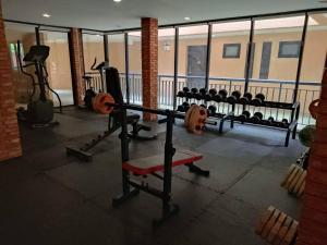 a gym with several rows of weights and machines at Studio apartments on a hill in Kathu