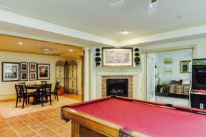 a pool table in a living room with a fireplace at Luxury Vacation Estate in Pottstown