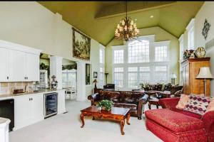 a large living room with a red couch and a table at Luxury Vacation Estate in Pottstown