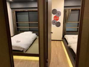 Postel nebo postele na pokoji v ubytování 匯金・押上ビル