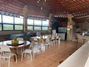 a dining room with tables and chairs and a kitchen at Villa Garita Inn in La Garita