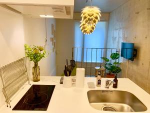 a kitchen counter with a sink and a mirror at Ken's Place四谷 in Tokyo +153 photos