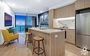 a kitchen with a large island with a counter top at Casino Private Apartments - QStay in Gold Coast