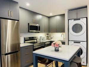 a kitchen with a table with a vase of flowers on it at Joes Brand New 2 King Bedrooms Townhome in Canmore in Canmore