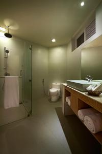 a bathroom with a shower and a sink and a toilet at Berjaya Hotel Colombo in Mount Lavinia