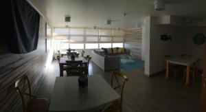 a living room with a table and chairs and a couch at Departamento Aqua La Serena in La Serena