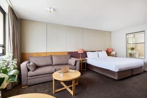 a hotel room with a bed and a couch at View Sydney in Sydney +76 photos