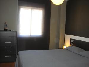 a bedroom with a bed and a window and a dresser at Torrox Boutique Apartaments - Paraiso Sol in Torrox Costa