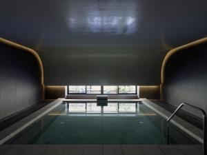 a swimming pool in a building with a window at SOKI KANAZAWA 19th November 2022 OPEN in Kanazawa