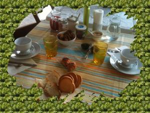 a table with a plate of food and drinks on it at La Casa di Ulisse B&B in Quercianella