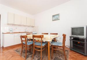 a kitchen and dining room with a table and chairs at Apartments Milan in Vlašići