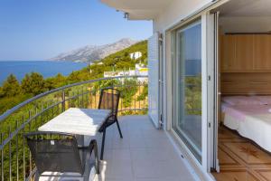 - un balcon avec un lit et une vue sur l'océan dans l'établissement Apartments Dream view, à Brela