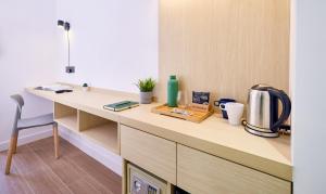 a kitchen with a desk with a coffee maker on it at South Nest in Hong Kong