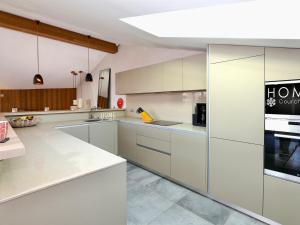 a large kitchen with white cabinets and appliances at Chalet Courchevel, 5 pièces, 10 personnes - FR-1-575-149 in Courchevel