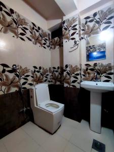 a bathroom with a toilet and a sink at Hotel Town View in Sauraha