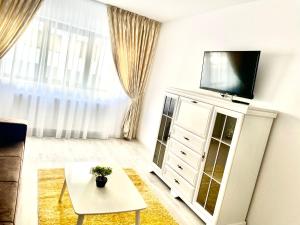 a living room with a tv on top of a dresser at Luxury apartments in Suceava