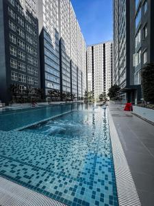 a swimming pool in a city with tall buildings at SUWAN Guesthouse A06 - 2BR Apartment with Pool Near UKM in Kajang