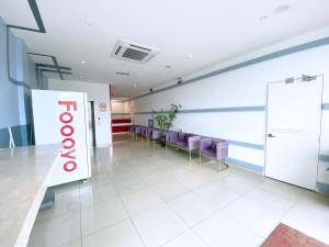 a waiting room with purple chairs and a sign at D'concept Hotel Kulim in Kulim