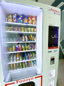 a refrigerator filled with lots of drinks and soda at D'concept Hotel Kulim in Kulim