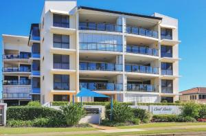 an apartment building with balconies and bushes at 404b Coral Sands in Bargara