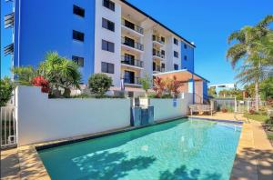 a swimming pool in front of a building at 404b Coral Sands in Bargara